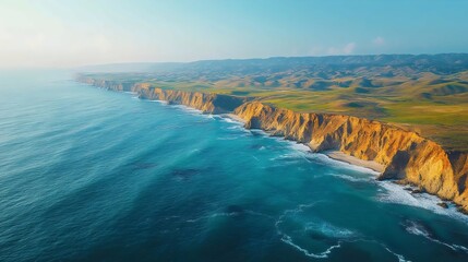 Fototapeta premium Stunning aerial view captures a dramatic coastal cliff overlooking the turquoise ocean waters.
