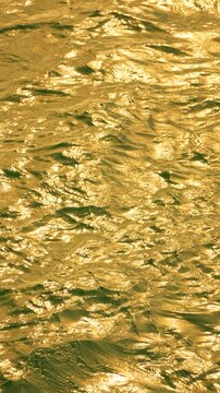 Water Sunlight Reflection: Glistening river water reflects sun at daytime, creates yellow-gold texture.