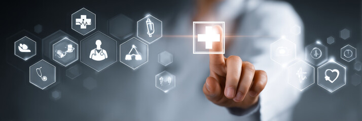 Medical worker interacts with digital interface, touching plus icon that symbolizes healthcare. This represents innovation in medical technology and patient care