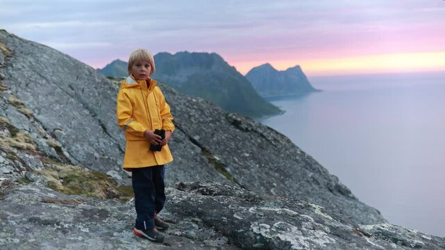 Children and adults, family with dog, hiking Grytetippen trail in Senja, Lofoten on a sunny summer day