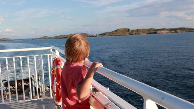 People, enjoying ferry ride between Bodo and Lofoten Moskenesoya summertime, child and adults on a ferry