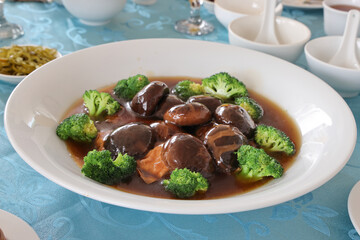 Chinese festive Braised Shiitake Mushrooms With Broccoli and bean curd in white dish
