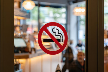 No smoking sign outside cafe. Red circle, crossed-out cigarette. Warning, smoking ban. Public place, health safety, anti-tobacco. Ban cigarettes in restaurant. Smoke free zone, no vaping