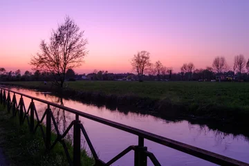 Fotobehang Purper Country landscape along the Canal of Martesana, Milan, Italy, at sunset  © Claudio Colombo