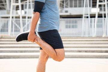 Senior old asian man wearing sportswear warming up before running outdoor. Portraits of Mature man...
