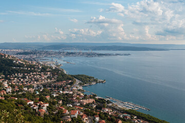 Fototapeta premium An aerial view shows the coastal city of Trieste overlooking the Adriatic Sea on a clear day. Trieste, Friuli Venezia Giulia, Italy.
