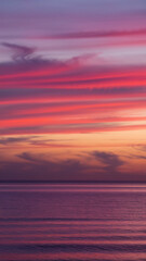 Fototapeta premium Sunset hues over a calm sea. Colors of twilight.