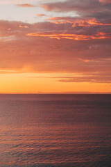 Obraz premium Sunrise over a calm ocean. Dramatic colors. Peaceful scene.