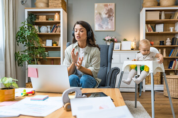 Young intelligent innovative single mother presenting her startup new business idea via video call...