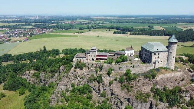 State Castle Kuneticka Hora With Green Fields In The Background In Raby, Czech Republic. - aerial shot