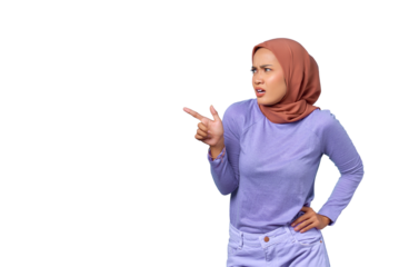 Portrait of shocked young Asian woman pointing finger at copy space isolated on transparent background