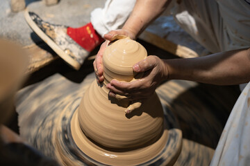 Capturing the Art of Pottery Making: Hands at Work on the Wheel