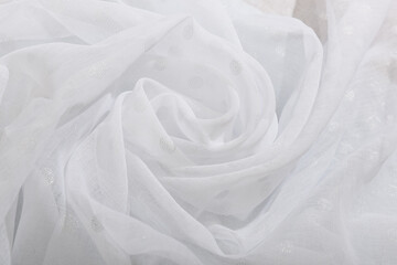 The texture of the white fabric. Wave fabric, textile, cloth, delicate textured material.