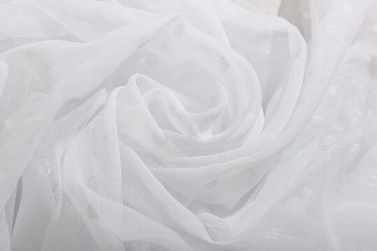 The texture of the white fabric. Wave fabric, textile, cloth, delicate textured material.