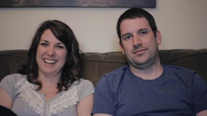 Bored spouses watching movie feeling disinterested at home. Man woman laughing