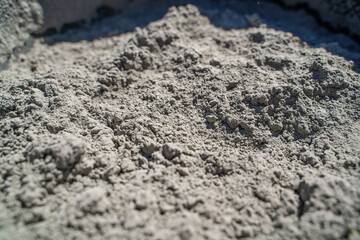 Dry cement close-up in a bucket on a sunny day
