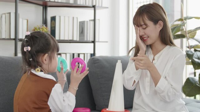 Cozy Living Room Moments Mother and Daughter Playing Joyfully Together with Colorful Toys