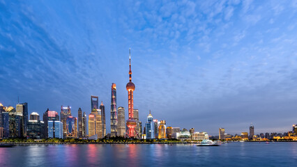 Stunning Evening View of Shanghai Skyline with Illuminated Architecture and Serene Waters