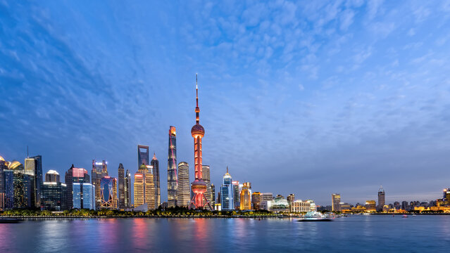 Stunning Evening View of Shanghai Skyline with Illuminated Architecture and Serene Waters