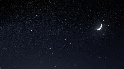 Fototapeta premium Crescent moon shines brightly in a dark starry night sky.