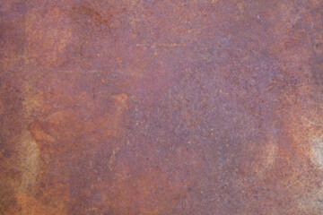 Rusty metal sheet with rich, textured corrosion patterns. Industrial background