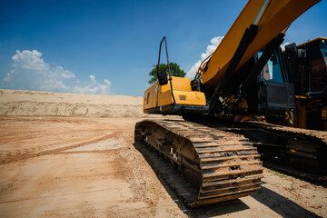 Obraz premium A Sand Moving Excavators: Two Excavators and Bulldozers Close-Up, Construction Equipment for Earthwork, Yellow Loader with Big Bucket on Construction, Construction Equipment