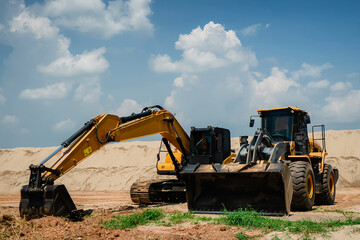 A Sand Moving Excavators: Two Excavators and Bulldozers Close-Up, Construction Equipment for Earthwork, Yellow Loader with Big Bucket on Construction, Construction Equipment