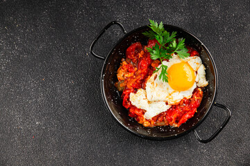 Fried egg tomatoes shakshuka vegetable dish appetizer fresh delicious gourmet food background on the table rustic food top view copy space vegetarian  food