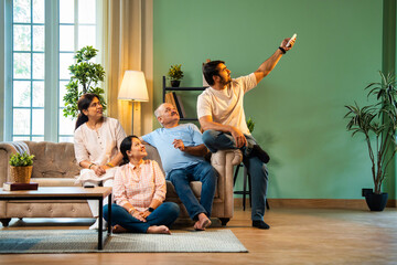 Sitting on sofa and sweating, Indian family cools down after daughter turns on AC with remote