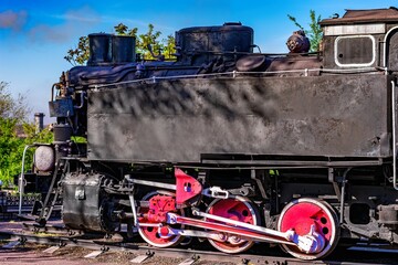 Vintage  train engine with striking wheels showcasing historical railway technology.