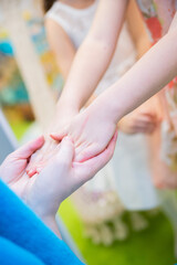 children's hands in the hands of adults family