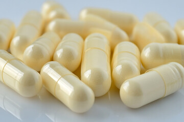 Pale yellow capsules medicine healthcare supplements health wellness pills close up