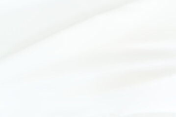 The bright white satin fabric texture is wavy and beautiful and luxurious. For background and backdrop.
