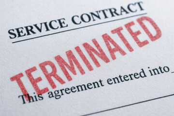 Fototapeta premium Service contract termination concept with red stamp on paper symbolizing end of agreement and legal conclusion