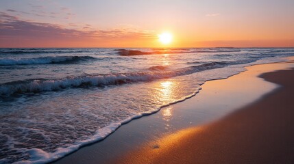 Obraz premium Serene beach sunset over calm ocean waves.