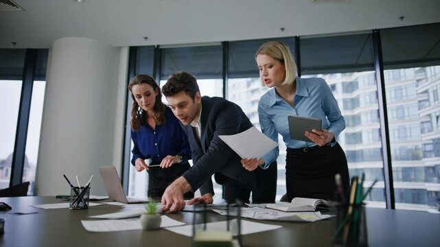 Office team working paperwork at table conference room. Professional teammates