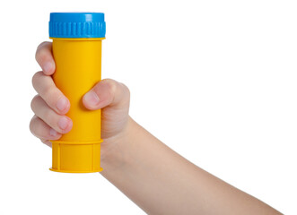 Plastic yellow bottle of soap bubbles in hand isolated on white background