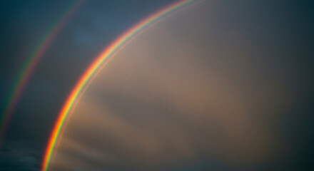 Double Rainbow Arching Across Sky After Storm Creates Colorful Natural Phenomenon