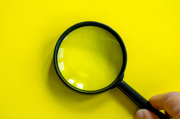 Hand holding a magnifying glass with customizable space for text.