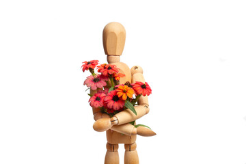 A wooden mannequin toy holding red and orange flowers on white background