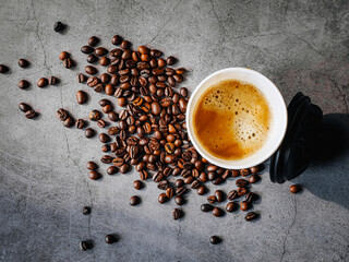 Coffee crema espresso in paper Coffee cup and bean on gray background, Top view of Espresso in  Takeaway paper coffee cup.