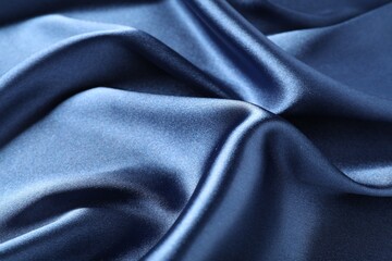 Blue crumpled silk fabric as background, closeup