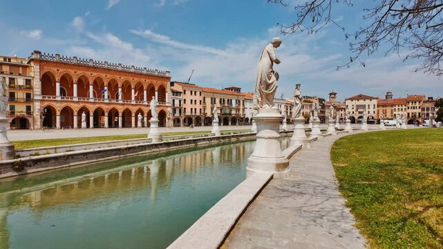 Prato della Valle Square presents an expansive plaza framed by classical colonnades and open greenery, Padua, Veneto, Italy