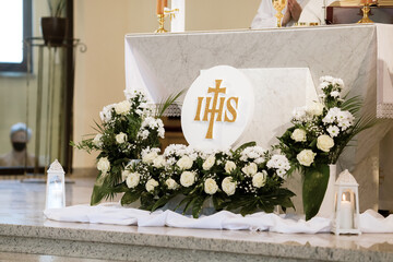 IHS Monogram Displayed in Church During First Holy Communion Ceremony