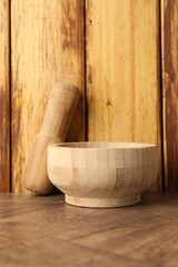Mortar and pestle on wooden table. Cooking utensil