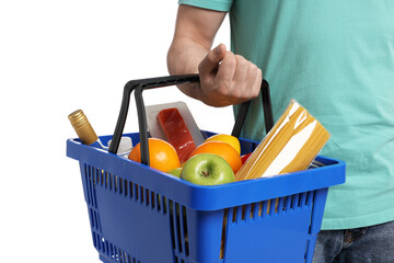 Man with shopping basket full of products on white background, closeup