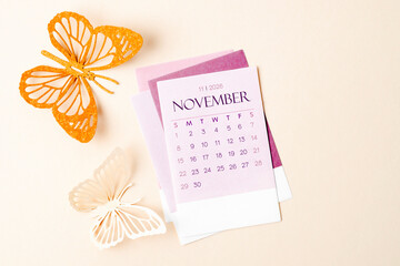 November 2026 calendar page with craft paper cutting butterfy shape.