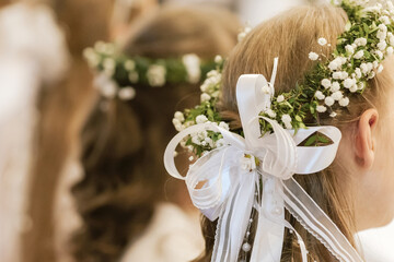 Beautiful Communion Hairstyle with Green Leaf Wreath on Girl During Holy Mass