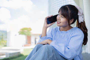 Digital nomad woman is working in coffee shop talking on phone with smile enjoying business and...