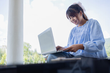 Digital nomad working on business project in coffee shop enjoys peaceful outdoor setting while...
